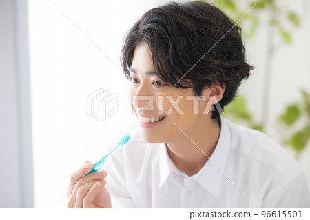 A man brushing his teeth 96615501