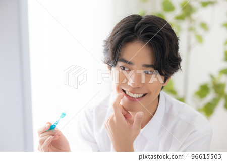 A man brushing his teeth A man brushing his teeth 96615503