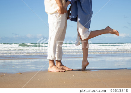 Romantic couple standing at seashore 96615848
