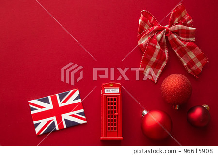 Christmas holiday tradition in United Kingdom and happy holidays flat lay, british flag, London telephone box and xmas decoration on festive red background as flatlay design, top view Christmas holiday tradition in United Kingdom and happy holidays flat lay, british flag, London telephone box and xmas decoration on festive red background as flatlay design, top view 96615908