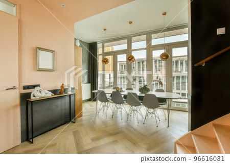 Couches and table located near TV against dining area of spacious room in contemporary apartment Couches and table located near TV against dining area of spacious room in contemporary apartment 96616081