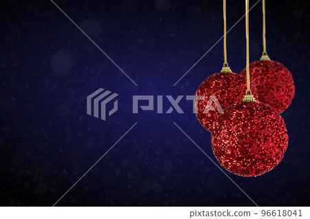 Christmas tree ornaments hanging. Balls made of glass or plastic hanging over abstract background Christmas tree ornaments hanging. Balls made of glass or plastic hanging over abstract background 96618041