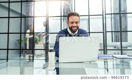 businessman working on a laptop in a modern office. businessman working on a laptop in a modern office. 96619573