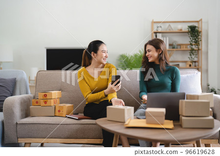 Two women busines startup for online marketing, Entrepreneur packing boxes parcels for shipping, SME sellers, and freelance online sales concept 96619628