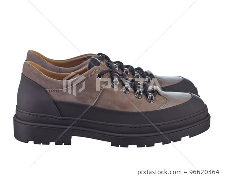 Side view of men's shoes, combined of beige suede and waterproof brown inserts, on a solid sole, isolated on a white background. 96620364
