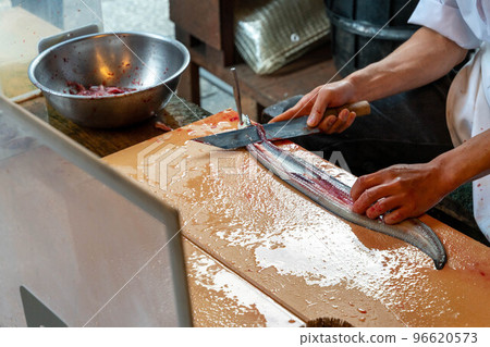 Hands of a craftsman who splits eels Hands of a craftsman who splits eels 96620573