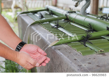 Men's hands purifying their hands at the chozuya Men's hands purifying their hands at the chozuya 96620983