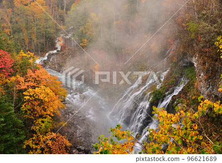 Shirahige Waterfall, Biei Town, Hokkaido, snow falls in autumn with red leaves 96621689