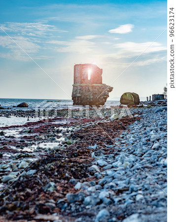 Ruins of the old gauge tower on shore bellow Cape Arkona cliff Ruins of the old gauge tower on shore bellow Cape Arkona cliff 96623174