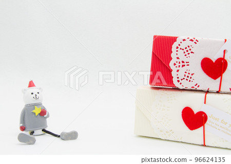 A bear doll wearing a Santa hat and a gift box 96624135