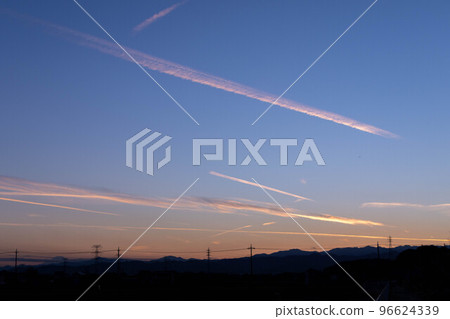 Sunset and an airplane cloud 96624339