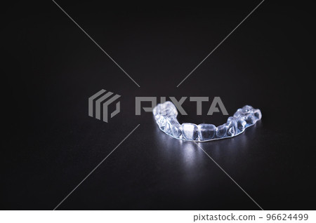 layout for orthodontics banner. transparent plastic aligners on black background layout for orthodontics banner. transparent plastic aligners on black background 96624499