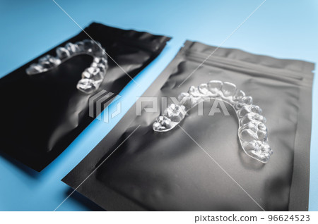 corrective aligners for the beauty of teeth lie on a black package. special storage bags. dentistry and health care corrective aligners for the beauty of teeth lie on a black package. special storage bags. dentistry and health care 96624523