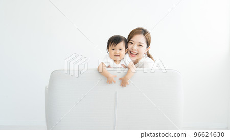 A mother holding a baby 96624630