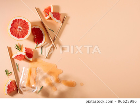 Grapefruit slices, rosemary, straws, and an empty glass. Grapefruit slices, rosemary, straws, and an empty glass. 96625986