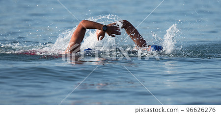 Triathlon swimmers churning up the water two swimmers in races in triathlon Triathlon swimmers churning up the water two swimmers in races in triathlon 96626276