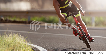 Road bike cyclist man cycling, athlete on a race cycle. Leaning into a corner 96626277