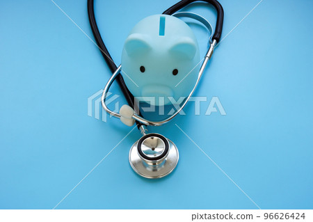 Blue piggy bank and stethoscope as symbol of health savings and medical insurance. 96626424