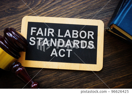 Plate with words Fair labor standards act FLSA and gavel. Plate with words Fair labor standards act FLSA and gavel. 96626425