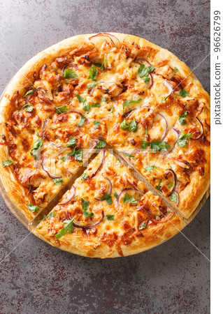 Tasty BBQ Chicken Pizza is a tasty California Pizza with barbecue sauce, cheese and onions closeup on the wooden board. Vertical top view Tasty BBQ Chicken Pizza is a tasty California Pizza with barbecue sauce, cheese and onions closeup on the wooden board. Vertical top view 96626799