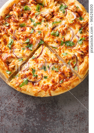 Homemade barbecue chicken pizza with onion and special sauce closeup on the wooden board. Vertical top view Homemade barbecue chicken pizza with onion and special sauce closeup on the wooden board. Vertical top view 96626800