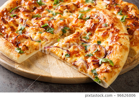 American California pizza with chicken, barbecue sauce, cheese and onions close-up on a wooden board. Horizontal American California pizza with chicken, barbecue sauce, cheese and onions close-up on a wooden board. Horizontal 96626806