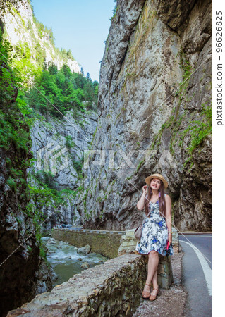 Woman in dress and straw hat in Bicaz Canyon 96626825