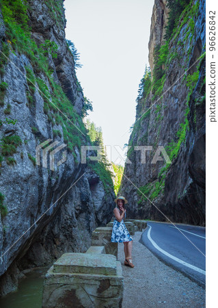 Woman in dress and straw hat in Bicaz Canyon Woman in dress and straw hat in Bicaz Canyon 96626842