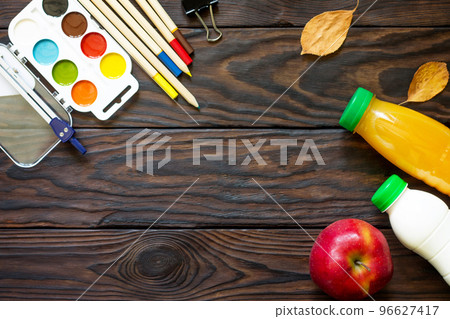 Back to school background with school supplies, autumn leaves and apple on a wooden table, copy space. Back to school background with school supplies, autumn leaves and apple on a wooden table, copy space. 96627417