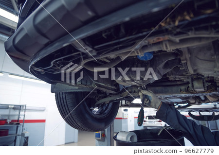 Car mechanic checks car on lift on Service station. Car mechanic checks car on lift on Service station. 96627779