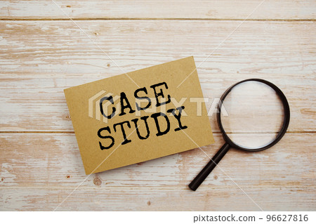 Case Study text message and magnifying glass with space copy on wooden background 96627816