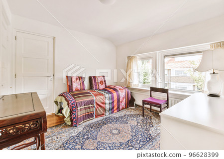 Comfortable sofa with soft cushions located under stylish chandelier inlight living room with arch Comfortable sofa with soft cushions located under stylish chandelier inlight living room with arch 96628399