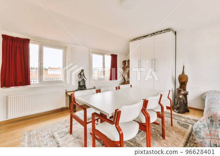 Comfortable sofa with soft cushions located under stylish chandelier inlight living room with arch 96628401
