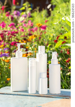 Set of cosmetic for skin care face, body on bright floral background. White blank cosmetics bottles. Natural Organic Spa Cosmetic Beauty Concept Mockup Front view Set of cosmetic for skin care face, body on bright floral background. White blank cosmetics bottles. Natural Organic Spa Cosmetic Beauty Concept Mockup Front view 96628583