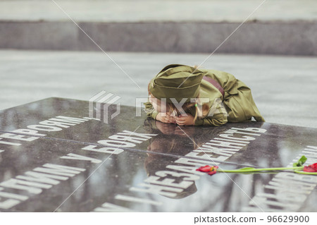 baby in Soviet military uniform leaned against the World War II stele baby in Soviet military uniform leaned against the World War II stele 96629900