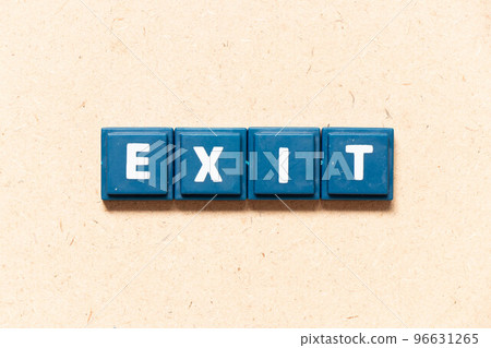 Tile letter in english word exit on wood background Tile letter in english word exit on wood background 96631265
