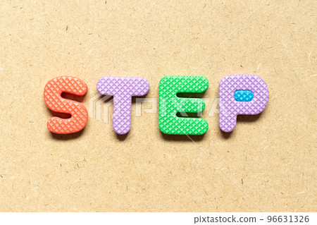 Foam alphabet letter in word step on wood background 96631326