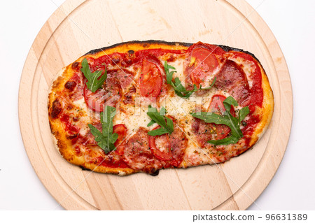 Delicious pizza served on wooden plate. 96631389