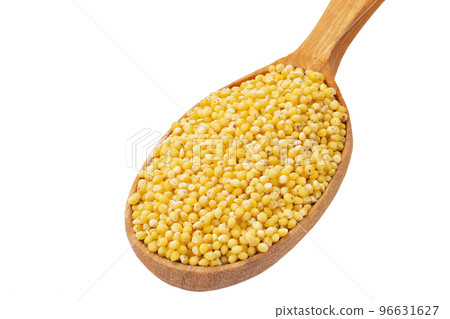 Dry millet groats in a wooden spoonl, isolated on white background. Full depth of field. 96631627