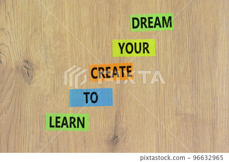 Create your dream symbol. Concept words Learn to create your dream on colored paper. Beautiful wooden table wooden background. Business learn to create your dream concept. Copy space. 96632965