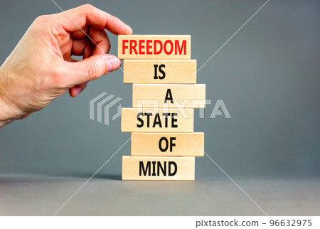 Freedom in mind symbol. Concept words Freedom is a state of mind on wooden blocks on a beautiful grey table grey background. Businessman hand. Business freedom is a state of mind concept. 96632975