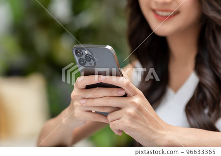 Close up hands of Happiness beautiful young woman use mobile phone for shopping online smile and enjoy with social media and laptop at home. Small Business Startup.online banking 96633365