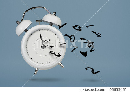Time is running out. White alarm clock with flying numbers as a symbol of lost time. The concept of time is running out, loss or lack of time, an alarm clock with numbers shatters into small pieces. 96633461