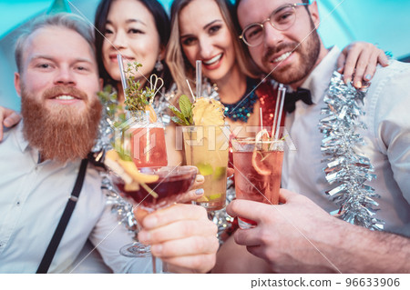 Portrait of diverse friends holding cocktails in hands Portrait of diverse friends holding cocktails in hands 96633906