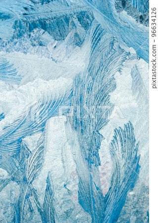 Winter frosty patterns on glass. Christmas festive background. Ice crystals on window. Winter frosty patterns on glass. Christmas festive background. Ice crystals on window. 96634126