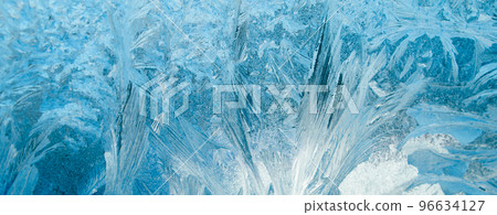 Frosty patterns on glass. Christmas background. Ice on winter window. Abstract crystals close up. Frosty patterns on glass. Christmas background. Ice on winter window. Abstract crystals close up. 96634127