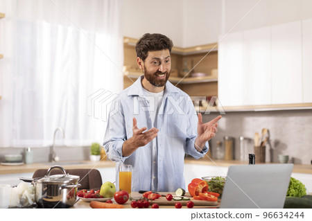 Cheerful middle aged caucasian man with beard has video call, make video for food blog, gesturing hands 96634244