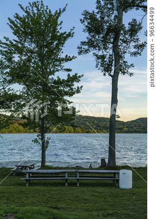White plastic barrel for garbage in a park near Rockland Lake, New York.  96634499