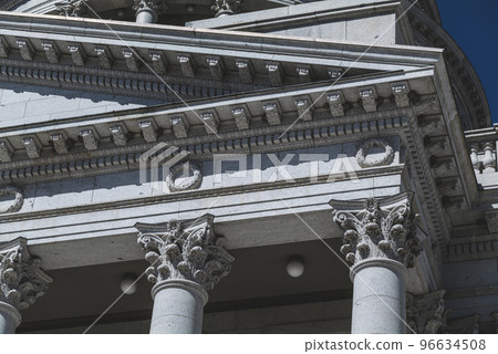 The architecture of buildings windows, stucco molding, and columns on a sunny day in the USA 96634508