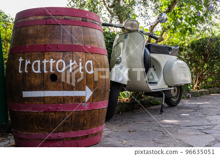 An antique Chianti wine barrel and a vespa scooter 96635051